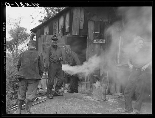 Untitled photo, possibly related to: Miners at Dougherty's mine, near Falls Creek, Pennsylvania, sharpening their axes at the end of a day's work