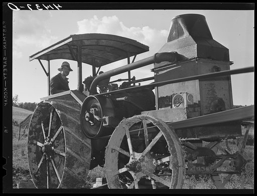 Tractor engine used to operate threshing machine at the farm of Alfred Shaffner, in submarginal farm area of Sugar Hill, near Townsend, New York