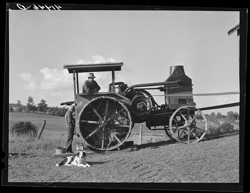 Untitled photo, possibly related to: Hired man working tractor engine used for threshing on farm of Alfred Shaffner, a farmer in the submarginal area of Sugar Hill, near Townsend, Connecticut