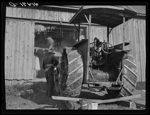 Untitled photo, possibly related to: Tractor engine used to operate threshing machine at the farm of Alfred Shaffner, in submarginal farm area of Sugar Hill, near Townsend, New York