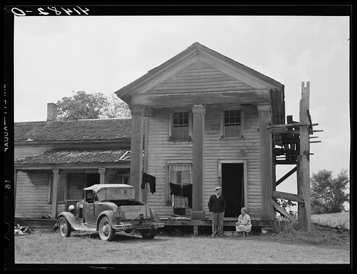 Mr. and Mrs. D'Annunzio in front of their house in Rumsey Hill. He was previously an unemployed auto mechanic in the city. Hasn't farmed much. Is trying to fix up the old house and roof before winter comes. They have been living in Rumsey Hill for a year. Near Erin, New York