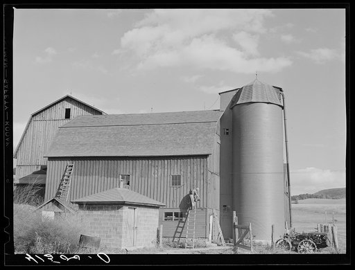 Painting a barn red just north of Tioga, Pennsylvania