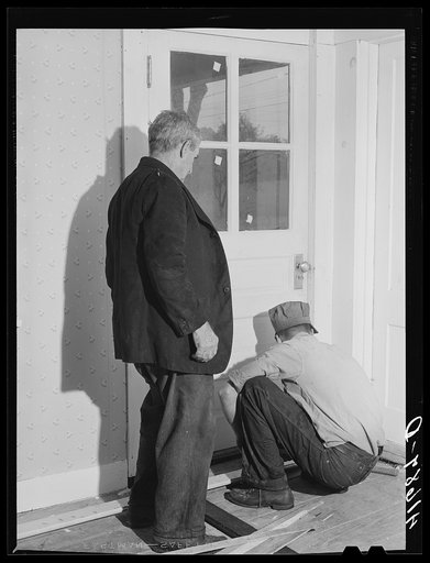 On a rainy day, Mr. Addison FSA (Farm Security Administration) client and his son are repairing the floor of their house near Middlefield, Connecticut