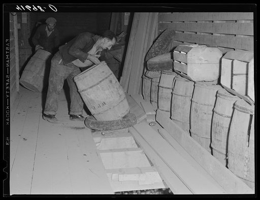 Untitled photo, possibly related to: Unloading potatoes into one of the underground bins of the storage barns of the Woodman Potato Comapany. Caribou, Maine