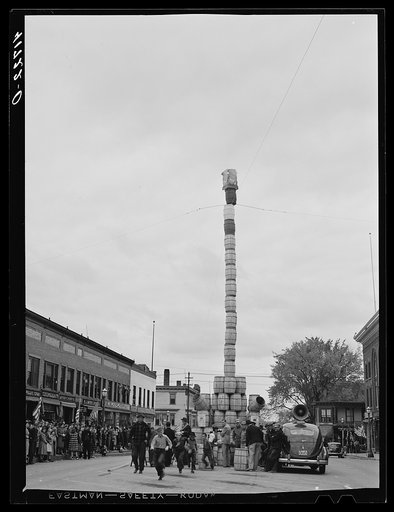Untitled photo, possibly related to: The "Pototem pole" standing in the main street of Presque Isle as an advertising stunt for the barrel rolling contest in Presque Isle, Maine