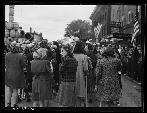 Untitled photo, possibly related to: Schoolgirls carrying Aroostook potatoes on sticks as part of the parade on the day of the barrel rolling contest in Presque Isle, Maine