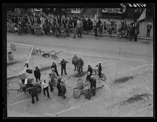 Weighing barrels of potatoes for the benefit of newsreel cameramen in Presque Isle Maine at the barrel rolling contest