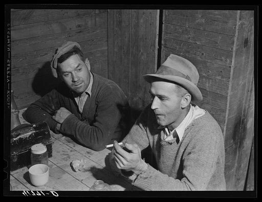 Workmen at the Woodman Potato Company just finishing lunch in the small room in the storehouse that serves as a lunchroom