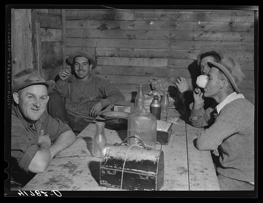 Workmen at the Woodman Potato Company just finishing lunch in a small room at the store house that serves as a lunchroom. Caribou, Maine