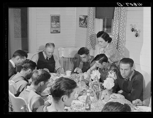 Lunch being served at one of the farms of the Woodman Potato Company. At the head of the table is Mr. Woodman. Only the foreman and skilled laborers eat here. Eleven miles north of Caribou, Maine