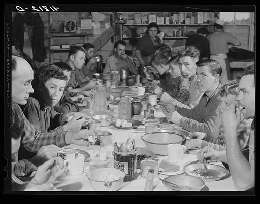 Lunch hour at one of the farms of the Woodman Potato Company. All of the pickers and field laborers eat in this converted tool house, eleven miles north of Caribou, Maine