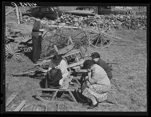 Women wait while their husbands bid at the auction of the farm of Mr. Anthony Yacek. Near Derby, Connecticut