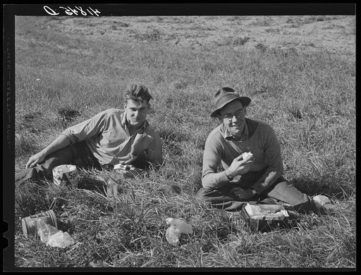 Two Caribou boys, one on left a foreman of a picking crew, working on a farm near Caribou. Most of them ate lunch out in the fields. Maine