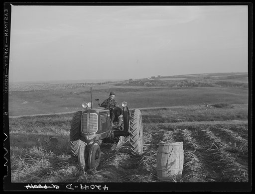 A community service tractor being operated. Claude Levesque on his farm near Van Buren, Maine