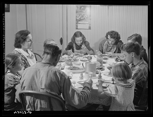 Dinner hour at the home of Mr. J.H. Dube, French-Canadian potato farmer, after he and the boys had finished a day's work in their potato field in Wallagrass, Maine