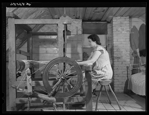 Mrs. Patrick Dumond, weaving toweling on a old loom in the attic. The Dumonds are French-Canadians and run a small farm in Lille, Maine. (FSA-Farm Security Administration clients)