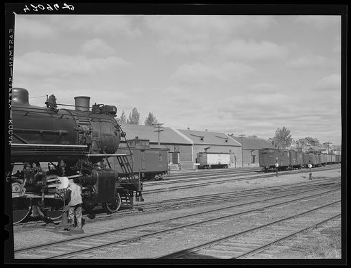 Untitled photo, possibly related to: Loading potatoes into a freight car at the freight terminal of the Bangor and Aroostook Railroad in Caribou, Maine