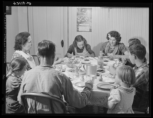 Untitled photo, possibly related to: Dinner hour at the home of Mr. J.H. Dube, French-Canadian potato farmer, after he and the boys had finished a day's work in their potato field in Wallagrass, Maine