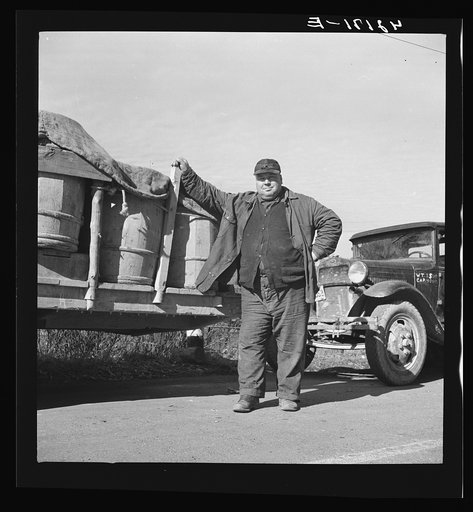 French-Canadian potato farmer waiting with a truckload of potatoes at a starch factory in Caribou, Maine for his potatoes to be graded and weighed