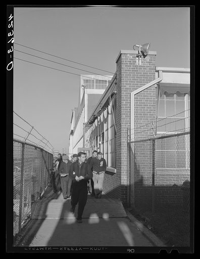 Workmen leaving the plant at Vought Sikorsky Aircraft Corporation. Stratford, Connecticut