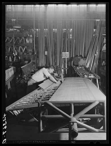 Working on a wing assembly at the Vought Sikorsky Aircraft Corporation. Stratford, Connecticut