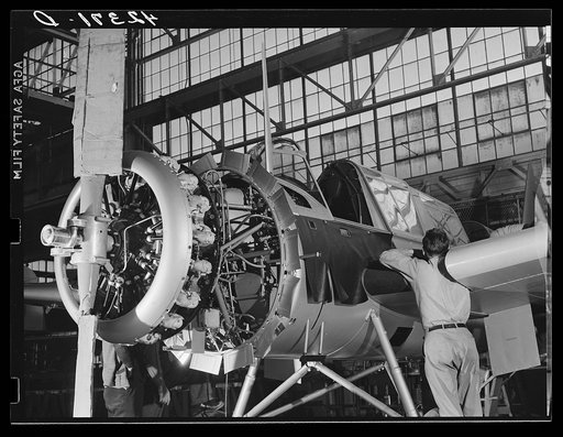 Workmen on the final assembly of a plane at the Vought Sikorsky Aircraft Corporation. Stratford, Connecticut