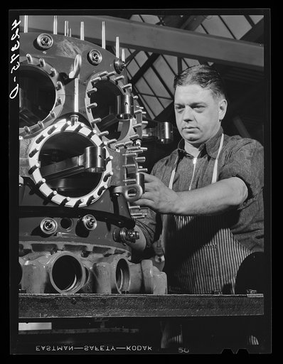 Working on the assembly of a Pratt and Whitney Engine. At the plant in East Hartford, Connecticut