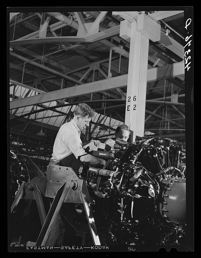 Working on the final assembly of Pratt and Whitney Aircraft motors at the plant in East Hartford, Connecticut