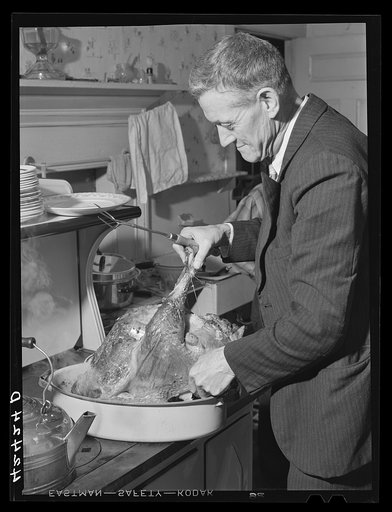 Ledyard, Connecticut. Mr. T.L. Crouch, a Rogerine Quaker, preparing to carve the Thanksgiving turkey