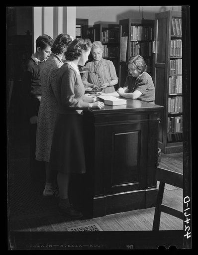Checking old books at the library at Colchester, Connecticut