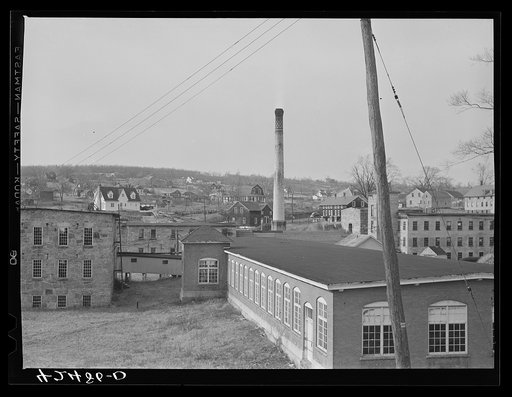 An old textile mill in Montville, Connecticut. In the background are small subsistence farms