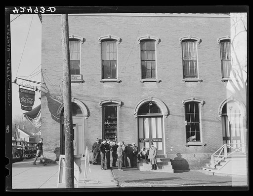Crowd of men in Taftville, Connecticut, waiting on the three o'clock shift to go in at the mill