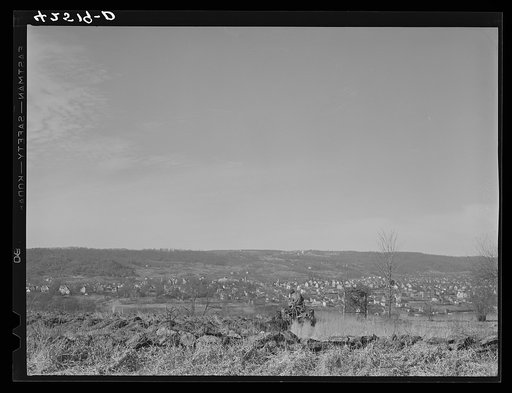 Untitled photo, possibly related to: Farmer ploughing his field on a hillside opposite the industrial valley including the towns of Darby, Shelton, and Ansonia, Connecticut