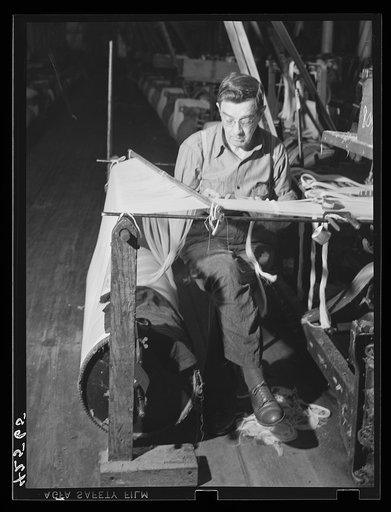 Tying together the thousands of separate strands for a loom in the Denomah Mills, Taftville, Connecticut. Makers of rayon and cotton cloth