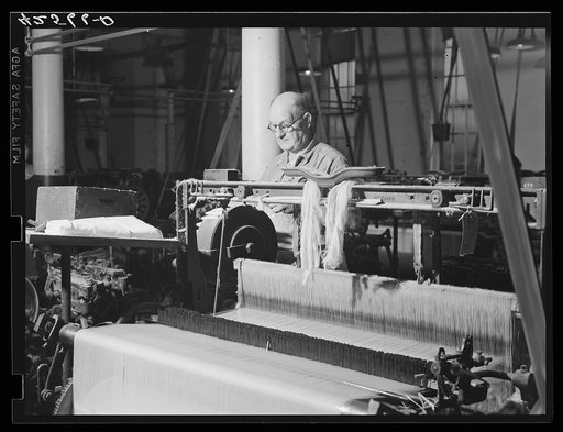 At a loom in the Denomah Mills, Taftville, Connecticut. Makers of rayon and cotton cloths