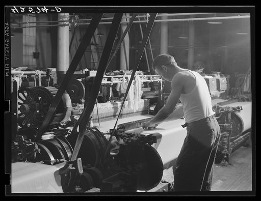 At a loom in the Denomah Mills, Taftville, Connecticut. Makers of rayon and cotton cloths