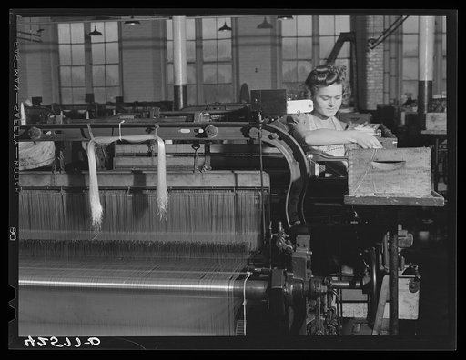 At a loom in the Denomah Mills, Taftville, Connecticut. Makers of cotton and rayon cloths