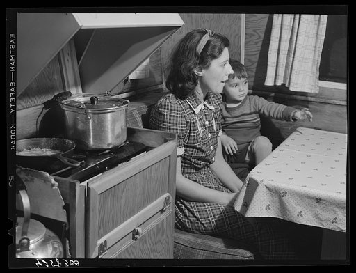 Mrs. Burton and her child, inside trailer (see caption #42581-D). Bath, Maine