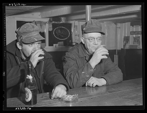 Shipyard workers stop in for a "beer" after work. In a bar just outside the Bath Iron Works. Bath, Maine