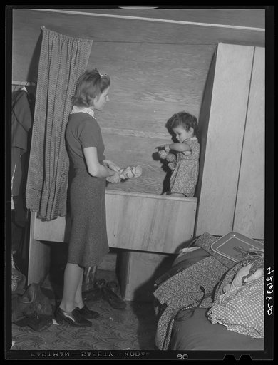 Untitled photo, possibly related to: Mrs. Robert R. Reynolds and her little girl. Mr. Reynolds works at the Bath Iron Works. They came to Bath about three months ago from Bethel, Maine and have been living in the trailer since they came. Get water, etc., from house nearby