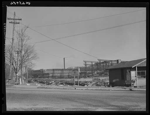 A large parking lot with the shipyards in the background. Quincy, Massachusetts