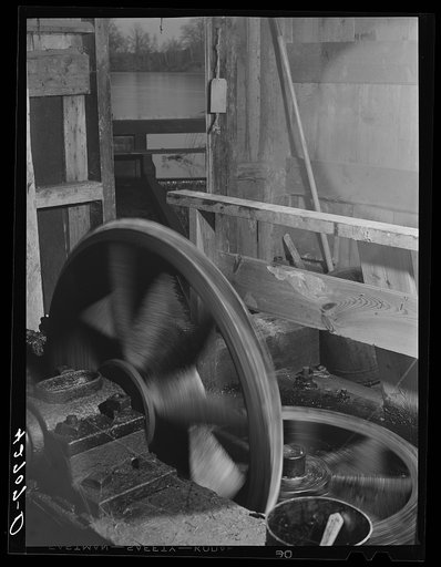 The old Kenyon's johnnycake flour mill in Usquepaugh is run by water power. The waterwheel is underneath the mill and by means of these two gears its power is brought into the mill
