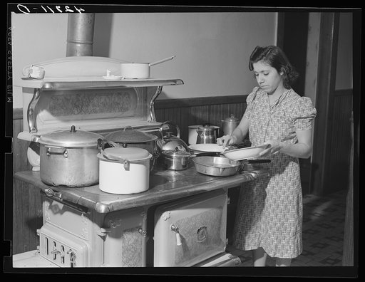 One of the daughters of Mr. Ilullo, Italian FSA (Farm Security Administration) client and truck gardener. She is preparing spaghetti and meatballs. Portsmouth, Rhode Island