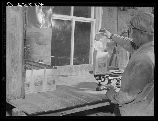 Untitled photo, possibly related to: Filling pound boxes of Kenyon's pancake flour at the old mill in Usquepaugh, Rhode Island