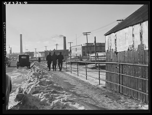 Men going home from work on a street in Lawrence, Massachusetts