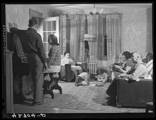 The Forgetta family, Italian vegetable farmers in Andover, Massachusetts. Mr. Forgetta, (right) and his older daughter (at the piano) both work in nearby textile mill in the winter if they can get the work