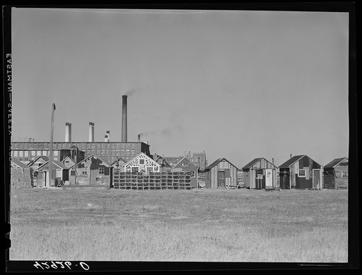 Fisherman's shacks in front of a mill along the waterfront in New Bedford, Massachusetts. Lobster traps in foreground