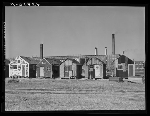 Untitled photo, possibly related to: Fisherman's shacks in front of a mill along the waterfront in New Bedford, Massachusetts. Lobster traps in foreground