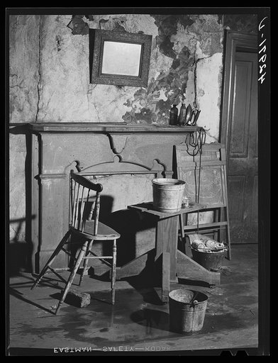 Buckets placed in room to catch water from leaky ceiling in a house in Mount Washington district. Beaver Falls, Pennsylvania