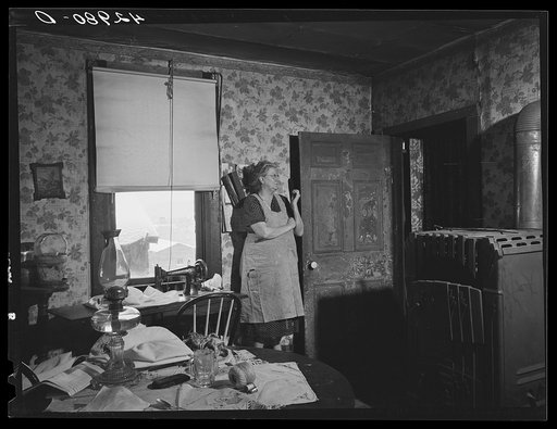 Woman in dilapidated old house in the Mount Washington district of Beaver Falls, Pennsylvania. She is blind in one eye and her other one is going bad to0. She expressed the hope that she would lose her sight completely so she could get some money from blind pension